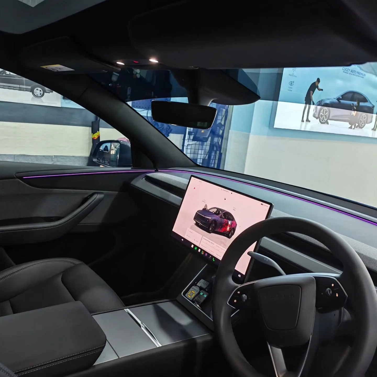 Tesla Model Y interior, looking out through the windscreen and front side window